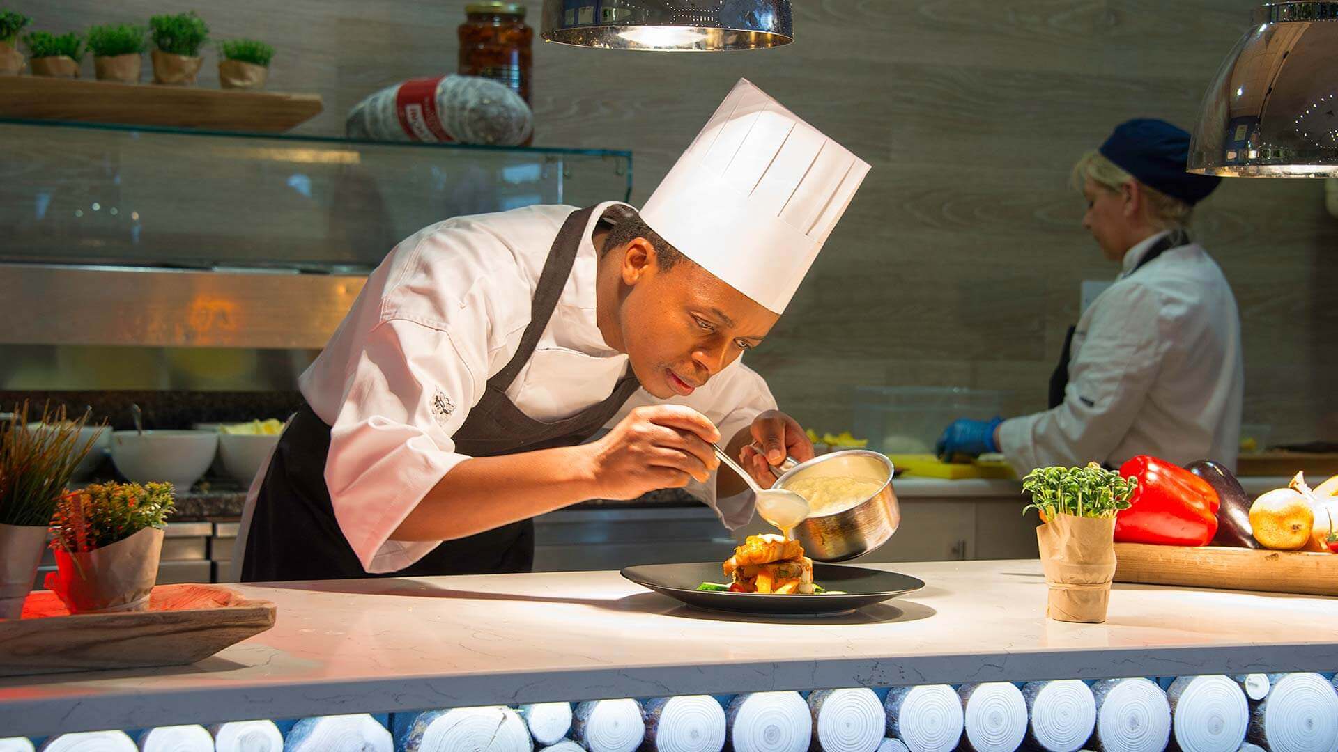 Chef adding sauce to a dish in Cork Airport Hotel restaurant