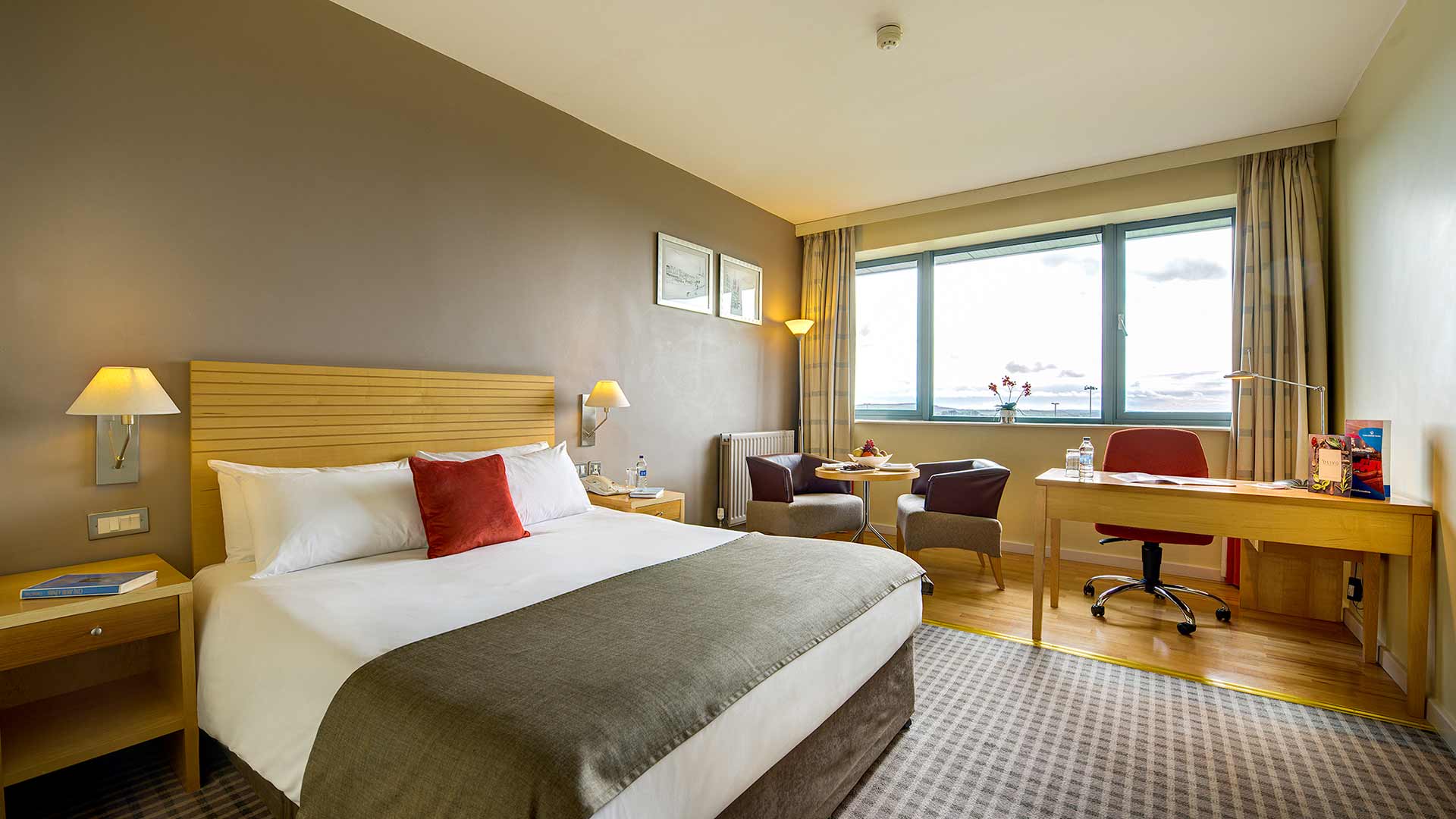 Double room at Cork Airport Hotel including comfy double bed, seating area and desk