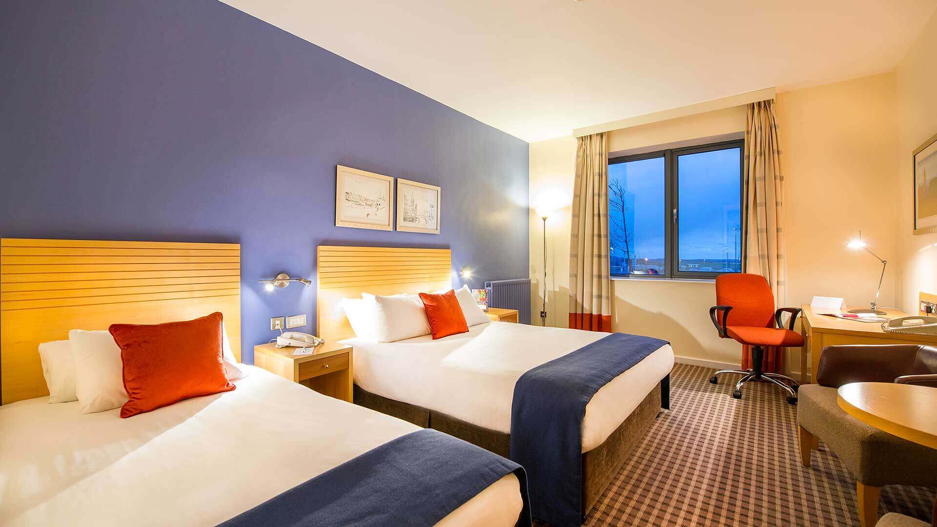 Family Room at Cork Airport Hotel with two comfortable, roomy beds and seating area
