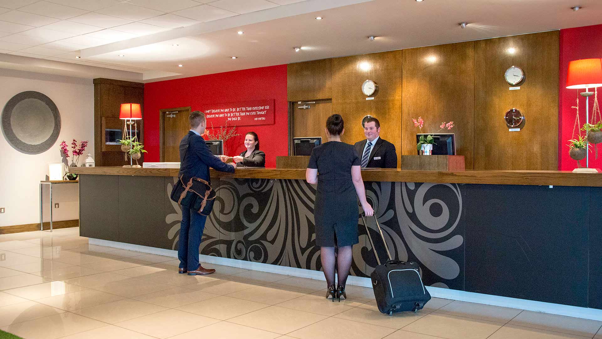 Two guests check in at the Cork Airport Hotel reception desk