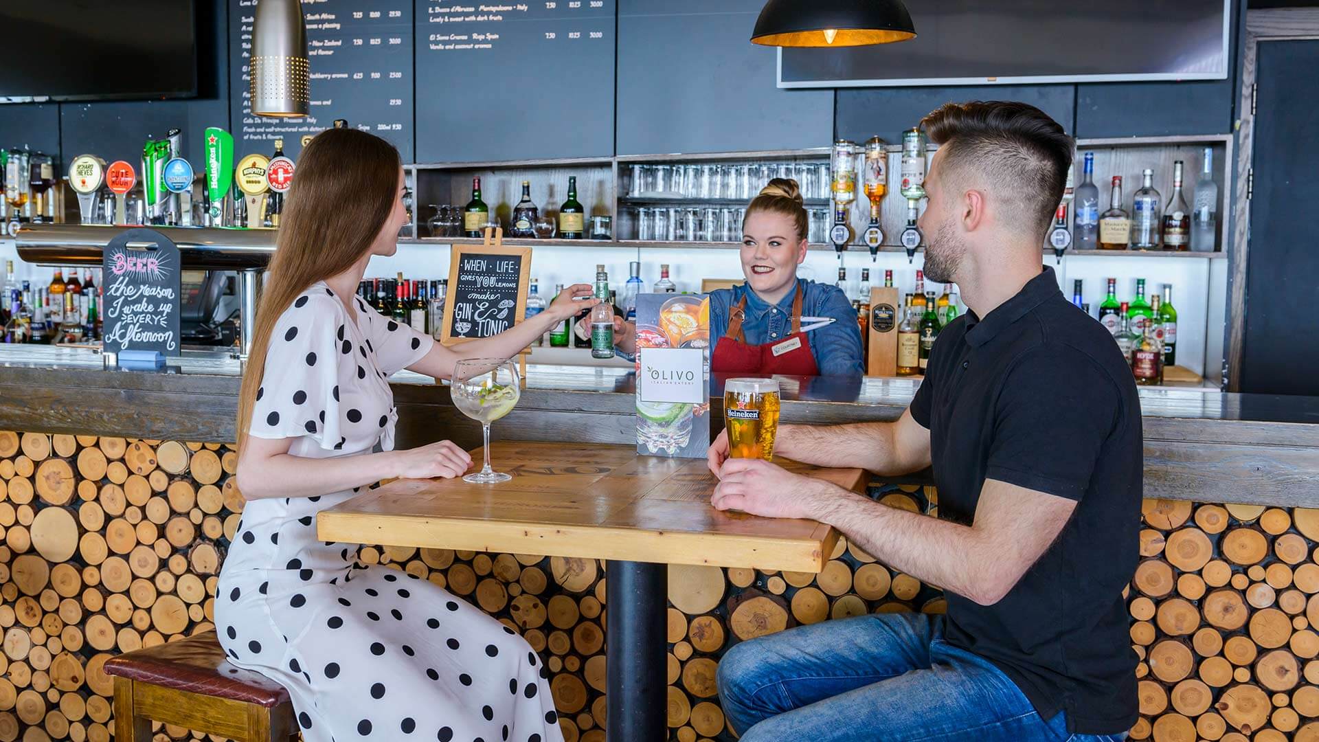 Two people enjoying drinks at the Olivo bar at the Cork Airport Hotel