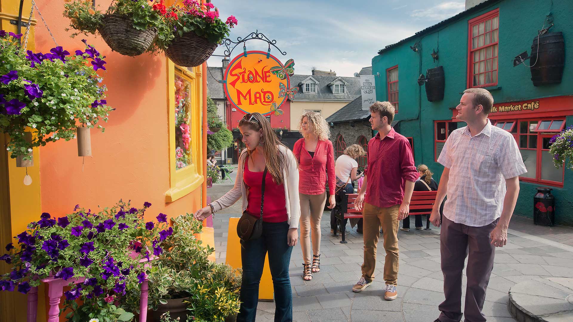 People explore Kinsale, Co Cork, passing the Stone Mad Gallery
